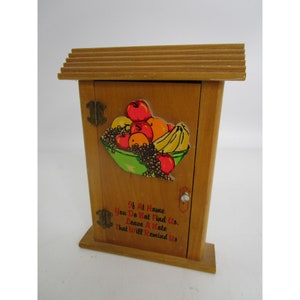 May include: A wooden key holder with a fruit motif and the text "If At Home You Do Not Find Us. Leave A Note That Will Remind Us."