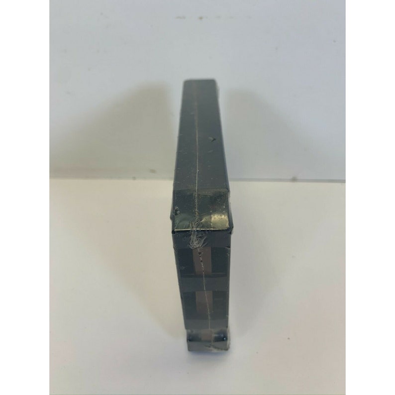 May include: A black VHS tape case with a brown and black striped design.
