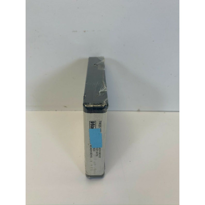 May include: A VHS tape case with a blue and white label. The label reads "Two's A Crowd" and "Beach Boys".