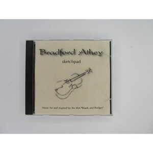 May include: A CD case with a beige background and black text that reads "Bradford Athey sketchpad". A black and white drawing of a violin is in the center of the case. The text at the bottom reads "Music for and inspired by the film "Roads and Bridges"".