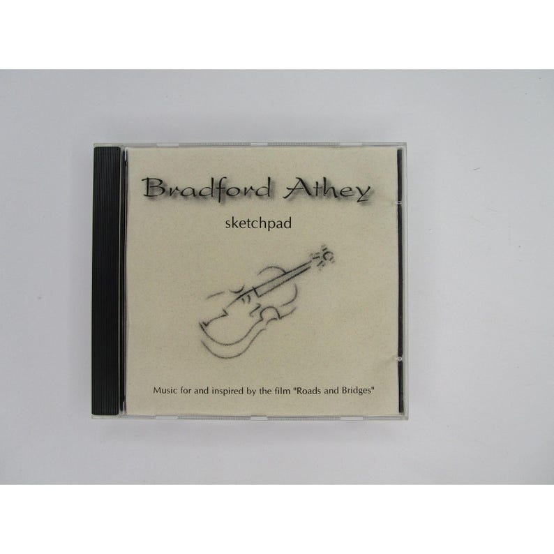 May include: A CD case with a beige background and black text that reads "Bradford Athey sketchpad". A black and white drawing of a violin is in the center of the case. The text at the bottom reads "Music for and inspired by the film "Roads and Bridges"".