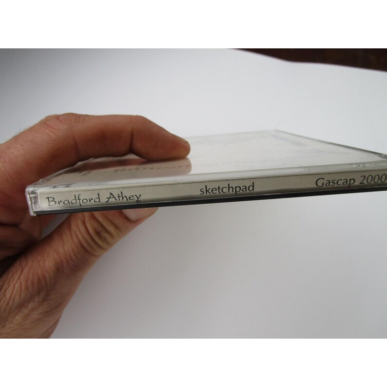 May include: Close-up of a CD case with the text "Bradford Athey" and "sketchpad" on the spine. The text "Gascap 2000" is on the right side of the case.