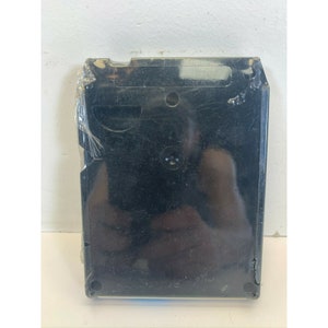 May include: Black plastic cassette tape case with the text "Made in Japan" printed on the back.