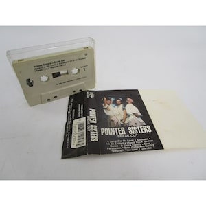 May include: A cassette tape case with a black and white photo of the Pointer Sisters on the front. The case is labeled "Pointer Sisters - Break Out" and lists the songs on the tape: "Jump (For My Love), Automatic, I'm So Excited, I Need You, Neutron Dance, Dance 2 Dance Electric, Easy Persuasion, Baby Come And Get It, Telegraph Your Love, Operator."