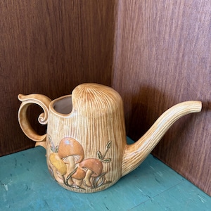 May include: A set of three ceramic mugs with a speckled, matte finish. Each mug is a different colour: light blue, cream, and grey. The mugs have a simple, modern design, ideal for coffee or tea.