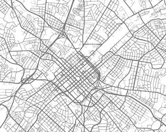 May include: A detailed black and white map of a city with a grid-like street layout. The map shows a dense network of roads and streets, with many intersections and curves. The map is centred on a large, central area, which appears to be the city's downtown.