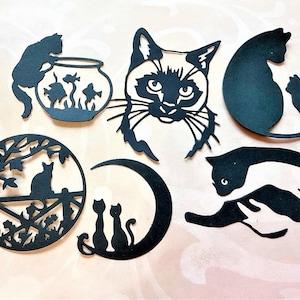 May include: A set of black silhouette cat cutouts, including a cat with a fishbowl, a cat with a crescent moon, a cat with a curled tail, a cat with a curled tail and a smaller cat, and a cat with a fishbowl and two fish.