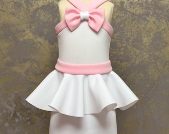 May include: A white dress with a pink bow and a pink belt. The dress has a ruffled skirt and a sleeveless bodice.