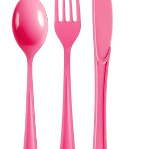 May include: A set of pink plastic cutlery, including a spoon, fork, and knife. The spoon has a rounded bowl, the fork has four tines, and the knife has a serrated edge. All pieces have long, tapered handles.