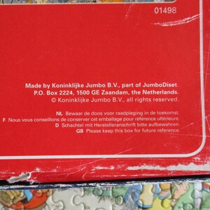 May include: A red cardboard box with white text reading Made by Koninklijke Jumbo B.V., part of JumboDiset. P.O. Box 2224, 1500 GE Zaandam, the Netherlands. &copy; Koninklijke Jumbo B.V., all rights reserved. The box shows signs of wear and scuffing.
