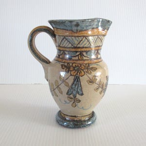 May include: A set of three ceramic mugs with a speckled, matte finish. The mugs are in shades of cream, light gray, and dark gray. Each mug has a simple, minimalist design, perfect for coffee or tea.