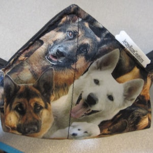 May include: A black fabric pouch with a zipper closure, featuring a colorful print of German Shepherd dogs. The pouch has a white label with the text "Jerry's Creations".