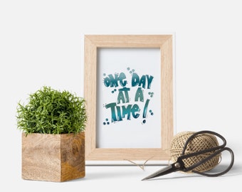 Hand Lettered “One Day at a Time” Quote in Digital Format PNG, JPG with Free Matching Phone Wallpaper