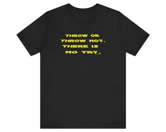 May include: A black short-sleeved t-shirt featuring yellow text printed on the chest that reads: THROW OR THROW NOT. THERE IS NO TRY. The garment has a crew neckline and a standard fit, with the text centered in a bold, sans-serif font style.