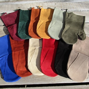 May include: A collection of 12 leather oven mitts in various colors, including blue, red, green, beige, and brown. The mitts are made of soft, supple leather and have a unique design with a pointed tip.