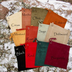 May include: A set of 12 small drawstring bags in various colors, including cream, mustard, mocha, olive, tobacco, driftwood, sage, rust, black, red, hunter green, and burgundy. Each bag has a label with its color name.