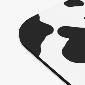 May include: Black and white cow print design on a white background. The design is a repeating pattern of black spots on a white background.