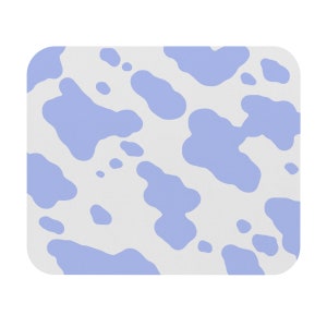 May include: A white and light blue mouse pad with a cow print pattern.