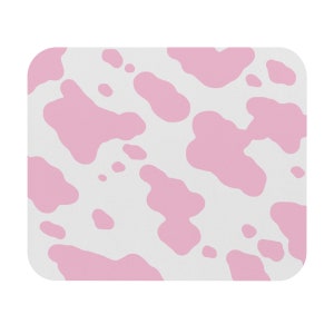 May include: A white background with pink cow print spots.
