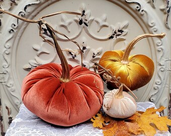 Velvet Pumpkins with Real Dried Pumpkin Stems in Fall Colors. Sold as a convenient set of three: Rust, Gold and Champagne Beige.