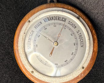 Vintage Mid Century German aneroid barometer with a wooden casing and weather indicators