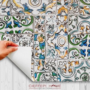 May include: A white background with a repeating pattern of blue, green, yellow, and brown floral tiles. The tiles are arranged in a patchwork design. The text "CIEFEEPI HOME COLLECTIONS" is at the bottom of the image.