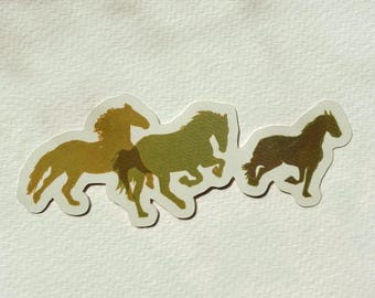 May include: A sticker featuring a silhouette of four horses running in a line. The horses are in shades of brown and green.