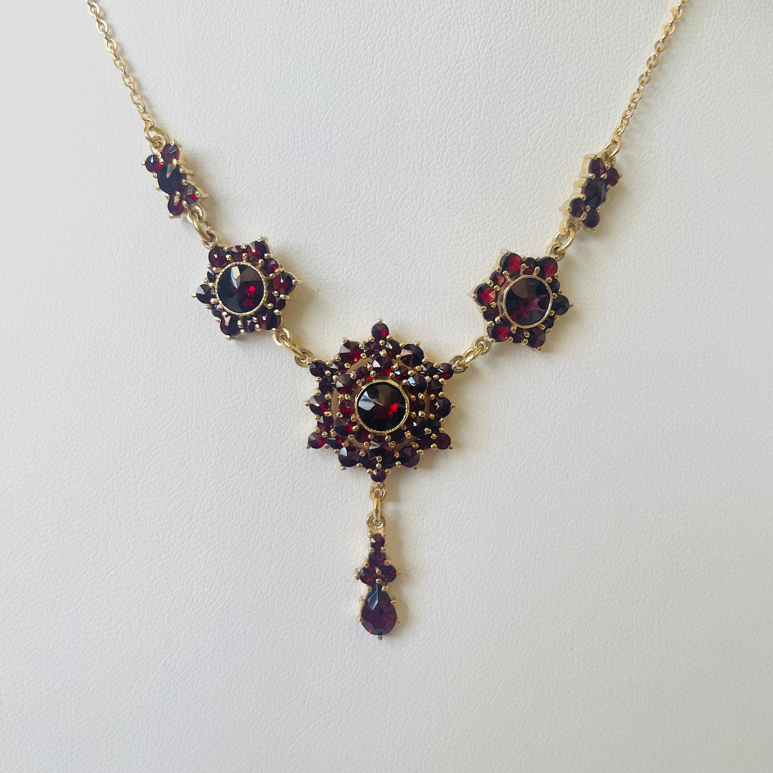 Vintage Bohemian garnet necklace with gold vermeil and clustered drop design on white background.