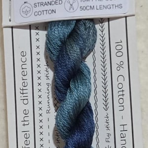 May include: A skein of blue and teal stranded cotton embroidery floss labeled "Lyrebird Walk." The label includes the text "10M pre-cut 50cm lengths" and "100% Cotton - Hand dyed in Australia."