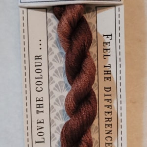 May include: A skein of Smoke Bush stranded cotton thread, pre-cut to 10m, with a dark brown color. The label reads "Love the Colour" and "Feel the Difference". The brand is CGT, hand dyed.