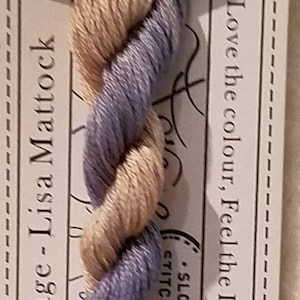 May include: A skein of Birch Bark stranded cotton embroidery floss. The thread is a blend of light tan and lavender colors. The label reads "Forage - Lisa Mattock" and "10M Pre-Cut".