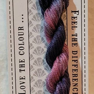 May include: Stranded cotton thread in shades of purple and pink, labeled "ALBERT" with the text "LOVE THE COLOUR" and "FEEL THE DIFFERENCE". The label also indicates 10 meters of pre-cut thread.