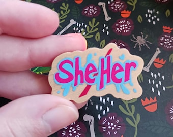 1.5" She/Her Paint Splatter Wood Pronoun Pin (DESTOCK)