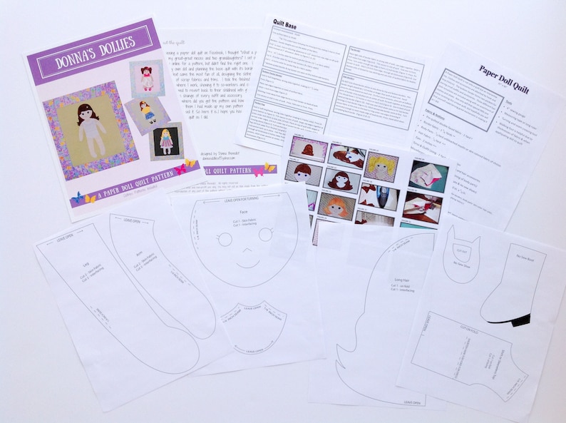 Op de afbeelding: Een set met papieren poppenquiltpatronen met een paarse achtergrond en de tekst "Donna's Dollies" en "A Paper Doll Quilt Pattern". De patronen omvatten een gezicht, lang haar, een jurk, een laars en een lange mouw.