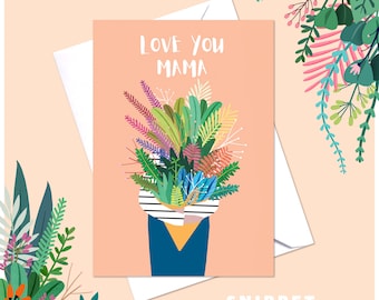 May include: A pink card with the text "Love You Mama" in black lettering. A bouquet of colorful flowers is in a blue vase with a white and black striped pattern.