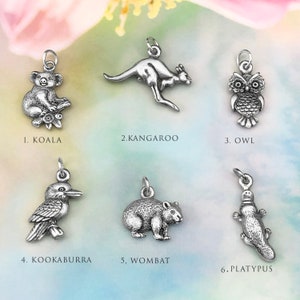 May include: Six silver charms depicting Australian animals: koala, kangaroo, owl, kookaburra, wombat, and platypus. Each charm is labelled with its corresponding animal name.