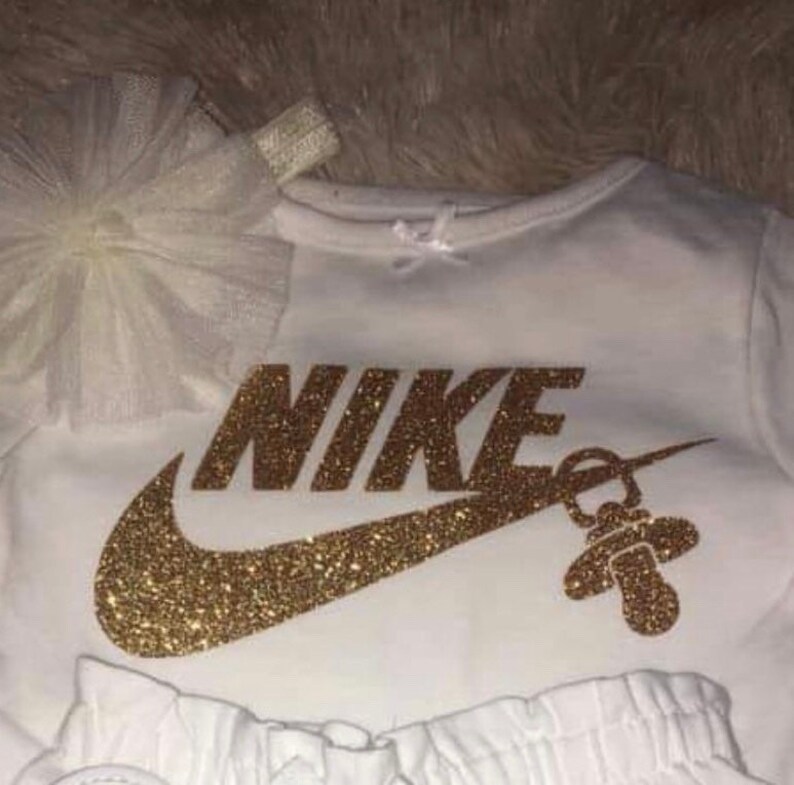 nike logo with pacifier