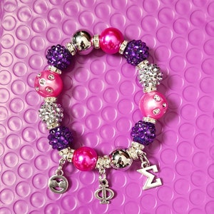 May include: A pink, purple and silver charm bracelet with a silver charm that says "Σ" and another charm that says "Φ".