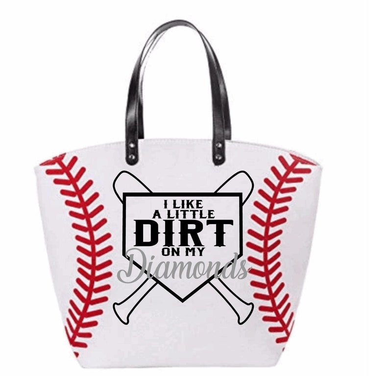May include: White canvas tote bag with a baseball diamond design and the text "I like a little dirt on my diamonds". The bag has black leather handles and red stitching.
