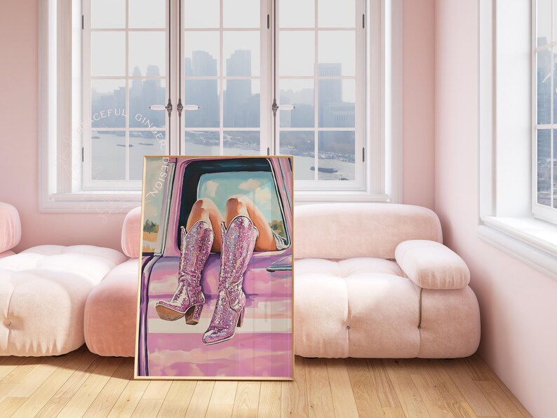 May include: A framed art print featuring a woman's legs in sparkly pink boots, resting on a pink car door. The artwork has a soft, painterly style with a pink and purple color palette. The word "DESIGN" is printed vertically on the left side of the frame.