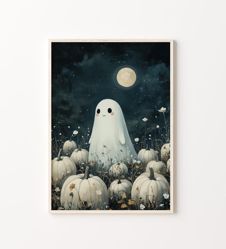 May include: A framed print featuring a whimsical illustration of a friendly ghost in a field of pumpkins under a full moon. The artwork has a soft, painterly style with a dark blue night sky and white pumpkins.