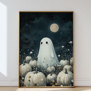May include: A framed art print featuring a friendly ghost in a field of white pumpkins under a full moon. The artwork has a whimsical, cartoonish style with a dark blue night sky and white flowers. The frame is gold.