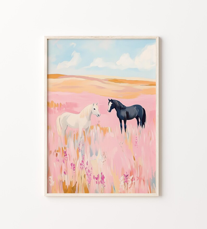 May include: A white horse and a black horse stand in a field of pink wildflowers. The sky is blue with white clouds.