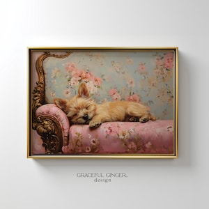 May include: A framed painting depicts a sleeping tan-colored dog on a pink floral couch. The background features a floral pattern in shades of pink and blue. The frame is gold. The words "GRACEFUL GINGER design" are at the bottom.