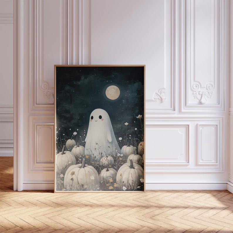 May include: A framed art print featuring a friendly ghost in a field of pumpkins under a full moon. The artwork has a whimsical, cartoonish style with a dark blue night sky and a light color palette. The print is in a wooden frame.