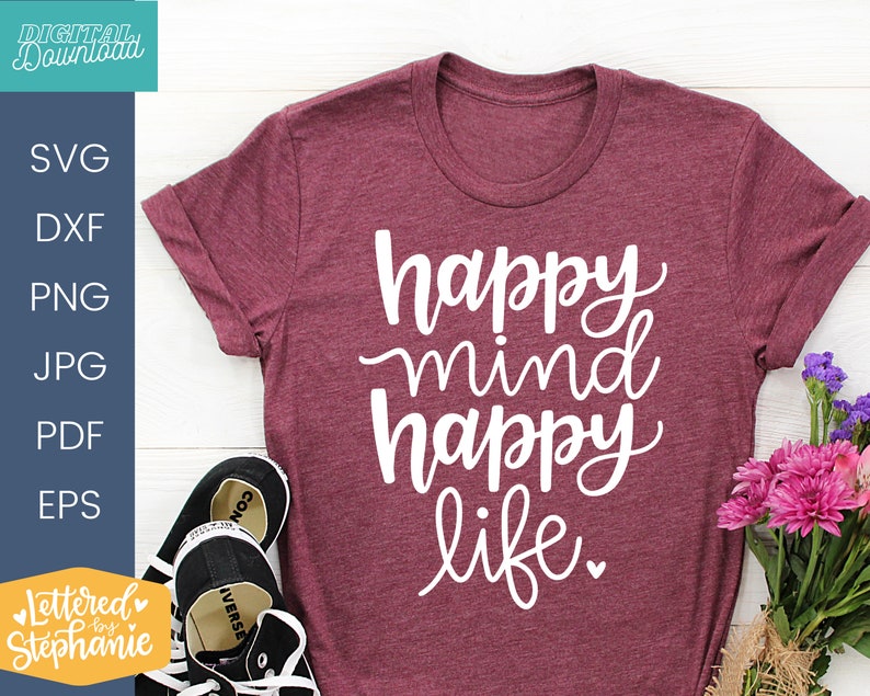 May include: A maroon t-shirt with the text "happy mind happy life" in white cursive lettering.