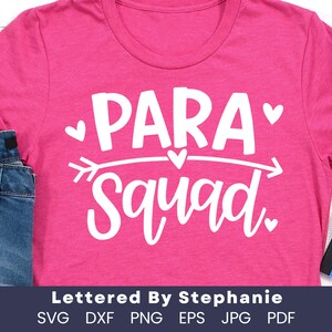 May include: Pink t-shirt with white text that reads "PARA Squad" with a heart and arrow graphic. The text "Lettered By Stephanie" is below the graphic. The text "SVG DXF PNG EPS JPG PDF" is below the text.