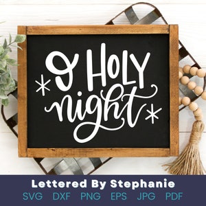 May include: A black chalkboard with a white wooden frame, displaying the text "O Holy night" in white cursive lettering with stars on either side.