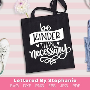 May include: Black tote bag with white text that reads "be kinder than necessary".