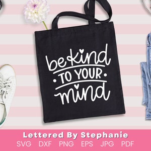 May include: Black tote bag with white text that reads "be kind to your mind" with a small heart above the word "kind" and two small hearts below the word "mind".